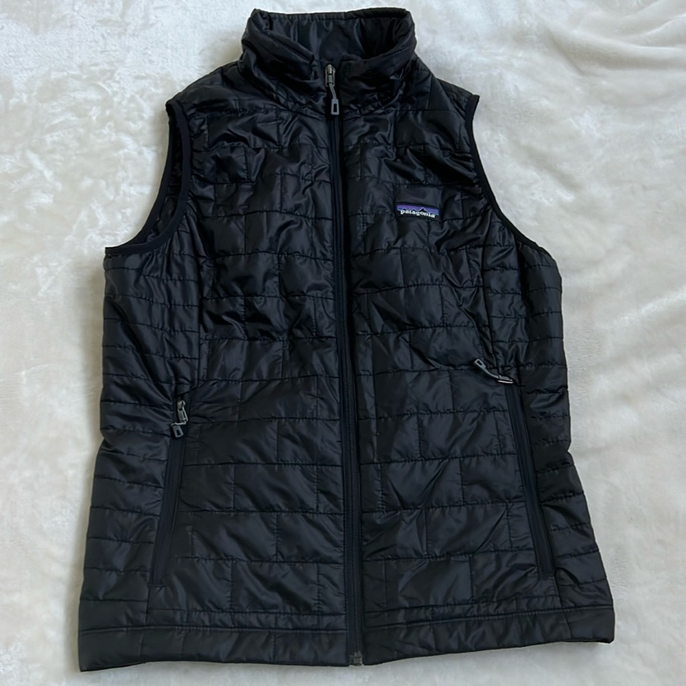 Black woman’s Patagonia quilted vest.